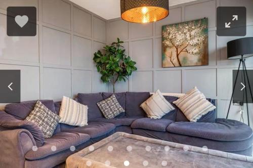 a living room with a purple couch with pillows at Luxury 2 BR Flat in Canary Wharf in London