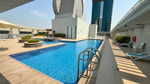 a swimming pool on the side of a building at Trinity Holiday Homes - Sheikh Zayed Road Right Next to Financial Center Metro Station Exit 1 in Dubai