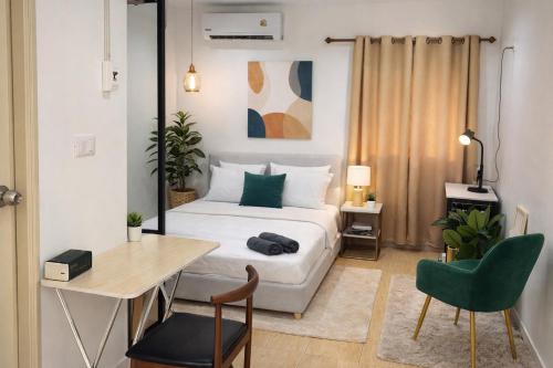 a bedroom with a bed and a desk and a chair at Similan Mondo Resort & Camping in Phangnga