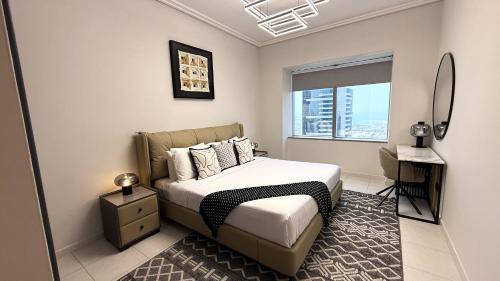 a bedroom with a bed and a window at Trinity Holiday Homes - Sheikh Zayed Road Right Next to Financial Center Metro Station Exit 1 in Dubai
