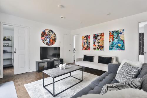 a living room with a couch and a table at FREE PARKING - 5 minute walk to METRO STATION Berri Uqam - In-Suite WASHER & DRYER - fully stocked KITCHEN - WORKSPACE PROVIDED - FAST WIFI in Montréal