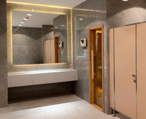 a bathroom with a sink and a mirror at Saffron Noble Apartment in Citaringgul 1