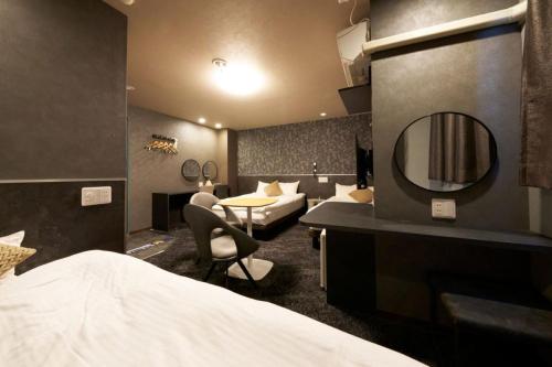 a hotel room with a bed and a mirror at Hotel Areaone Naruto in Naruto