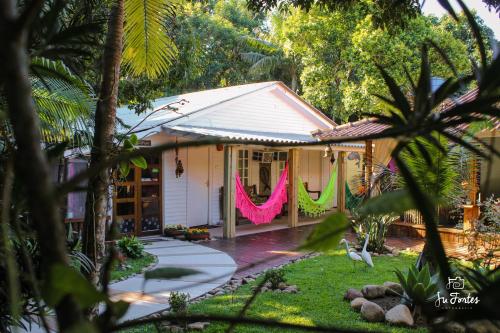 a house with a pink and green garland at Pousada Villa Maria in Ilha do Mel