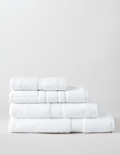 a stack of white towels on a white background at Sunset Sky Nest CBD 65F in Melbourne