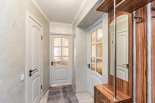 a hallway with a door and a mirror at Гоголя 117 in Almaty