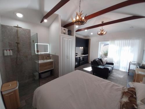 a bedroom with a bed and a bathroom with a shower at Elks Nook Retreat - Luxurious Escape - Perth Hills in Byford