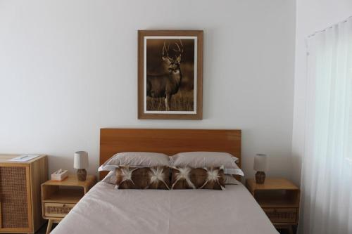 a bedroom with a bed with a picture of a deer at Elks Nook Retreat - Luxurious Escape - Perth Hills in Byford
