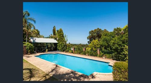a swimming pool in the middle of a yard at Elks Nook Retreat - Luxurious Escape - Perth Hills in Byford