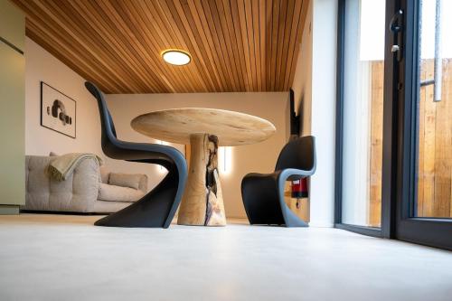 a table and chairs in a room with a table at Le Marzelheide 3 in Lontzen