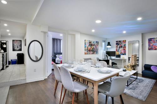 a dining room and living room with a table and chairs at 250 METERS to METRO BERRI UQAM - Spacious fully equipped APARTMENTS - 1 FREE PARKING per unit - in-unit Washer & Dryer - fully stocked KITCHEN - WORKSPACE PROVIDED - FAST WIFI - 5 minute walk to the FAMOUS ST CATHERINE & ST DENIS STREET in Montreal