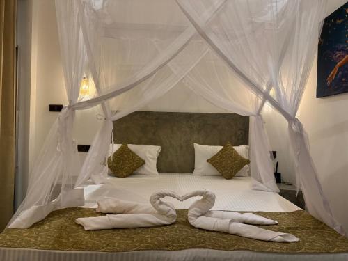 En eller flere senge i et værelse på The Nest - Near Hiriketiya Beach