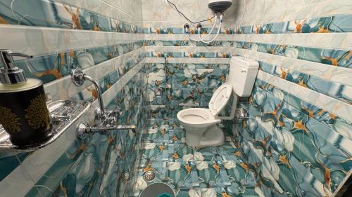 a bathroom with a toilet and a sink at Awadh homestay in Varanasi