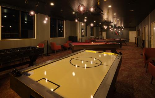 a ping pong table in a room with pool tables at Red 28 in Ito