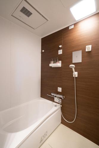 a bathroom with a bath tub and a sink at Vacation Rental NENBA in Hokuto