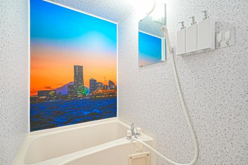 a bathroom with a bath tub with a window at Momotarou Stay in Yokohama