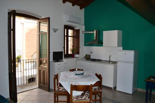 cocina con mesa y pared verde en Castelmilazzo en Milazzo