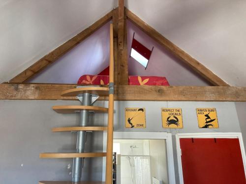 a bunk bed with a ladder in a room at Appartement centre in Quiberon