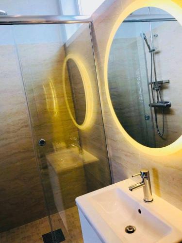 a bathroom with a sink and a shower with a mirror at Private apartment with hotel feeling in Hudiksvall