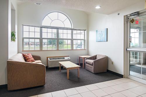 a living room with a couch and a chair at Motel 6-Sycamore, IL in Sycamore