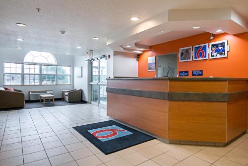 a hotel lobby with a counter and a restaurant at Motel 6-Sycamore, IL in Sycamore