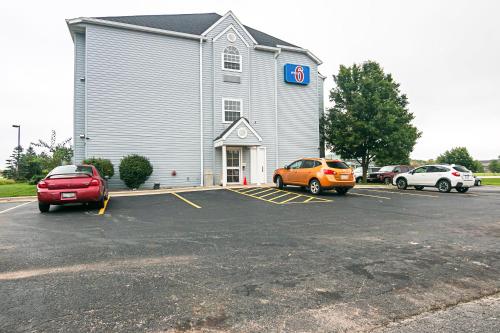 a church with two cars parked in a parking lot at Motel 6-Sycamore, IL in Sycamore