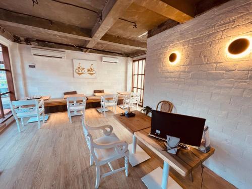 a room with chairs and a table with a computer at La Belle Villa in Seminyak