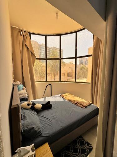 una piccola camera da letto con un letto e una finestra di Lovely studio inside Abu Dhabi a Abu Dhabi