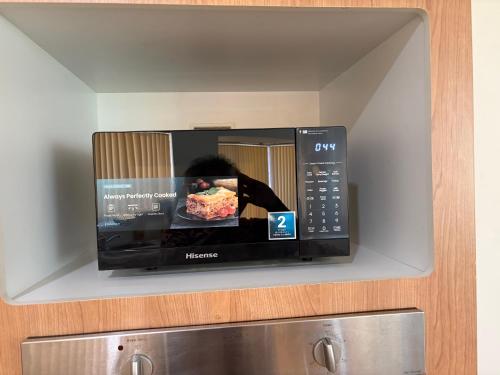 a microwave oven with a picture of a person inside at Bertram Family Retreat in Wellard