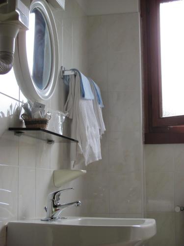 a bathroom with a sink and a mirror at Albergo La Genzianella in Miasino