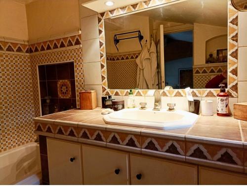 a bathroom with a sink and a large mirror at Paradis bleu in Agay - Saint Raphael