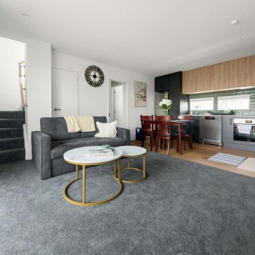 a living room with a couch and a table at Modern Heritage 2BR Home in Christchurch