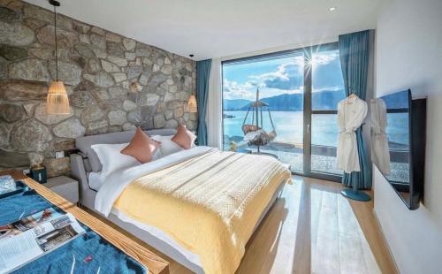 a bedroom with a large bed and a large window at Nanshe Nan Inn Dali in Dali Airport