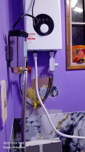 a machine in a room with aperature at Ingeritch Cabin Transient and Homestay in Baguio
