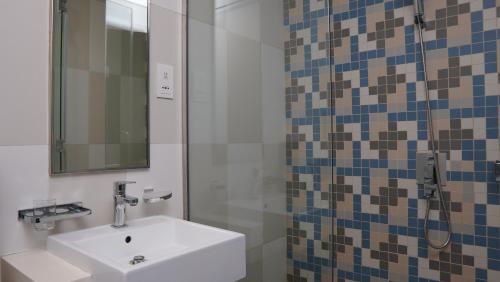 a bathroom with a sink and a mirror at Dimorelux l Club Vista Mare l Five Palm Jumeirah in Dubai