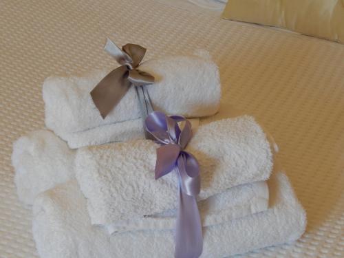 een stel handdoeken met een paars lint eraan bij Slow living beautiful villa in Rafina