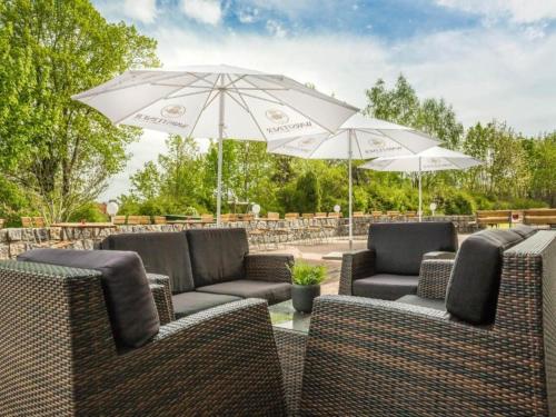 a group of chairs and umbrellas on a patio at Kaiserhof Feldberg by Belvilla Resorts in Feldberg