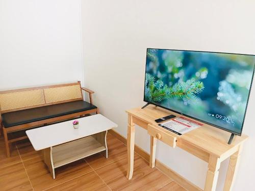 a living room with a flat screen tv on a table at First Light Garden House in Koh Phangan