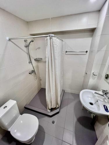 a bathroom with a shower and a toilet and a sink at Palma Beach Hotel in Kranevo