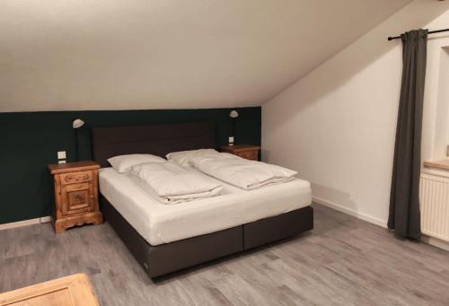 a bedroom with a bed and a wooden night stand at Family & Friends in Hopfgarten im Brixental