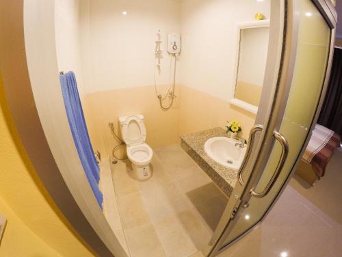 a bathroom with a toilet and a sink at Madam House in Karon Beach