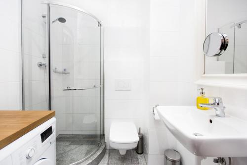 a bathroom with a shower and a sink and a toilet at Sweet Heart Home in Szczecin