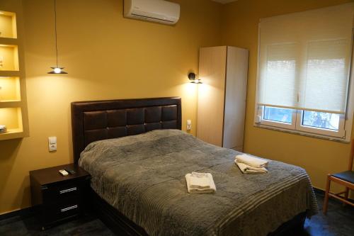 a bedroom with a bed with two towels on it at Sweet Studios Kavala in Kavála