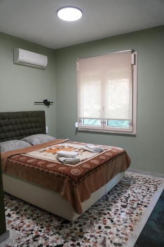 a bedroom with a bed and a window at Sweet Studios Kavala in Kavála