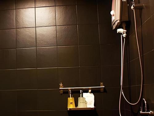 a bathroom with a shower and a sink with a shower at Iroom Hotel in Surat Thani