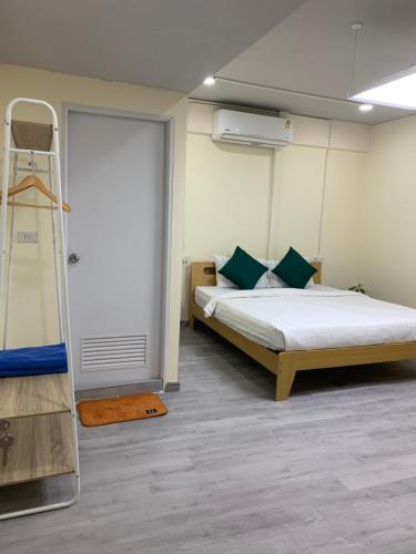 a bedroom with a bed and a ladder next to a door at Uncle Yo House in Ban Tha Khreng