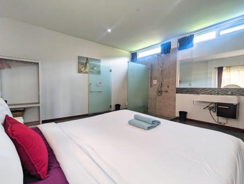 a bedroom with a large white bed and a shower at Blue Cove Pool Villa - by KohChangVillas in Trat