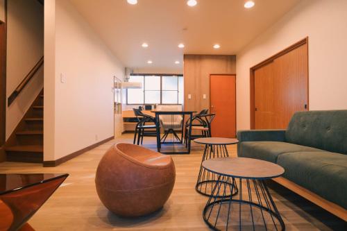 a living room with a couch and tables at rinne 北軽井沢 Forest3 in Tsumagoi