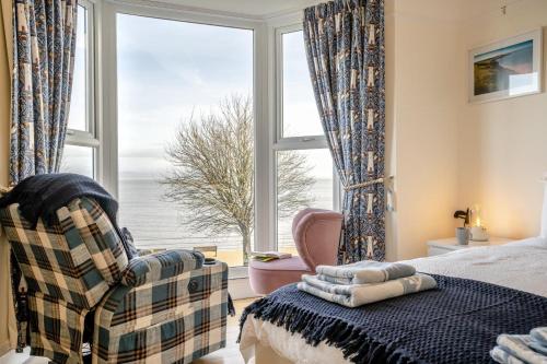 a bedroom with a bed and a large window at 5 Bed in Mumbles oc-l34618 in The Mumbles