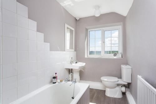 a bathroom with a tub and a toilet and a sink at 3 Bed in Ampleforth oc-m34673 in Ampleforth